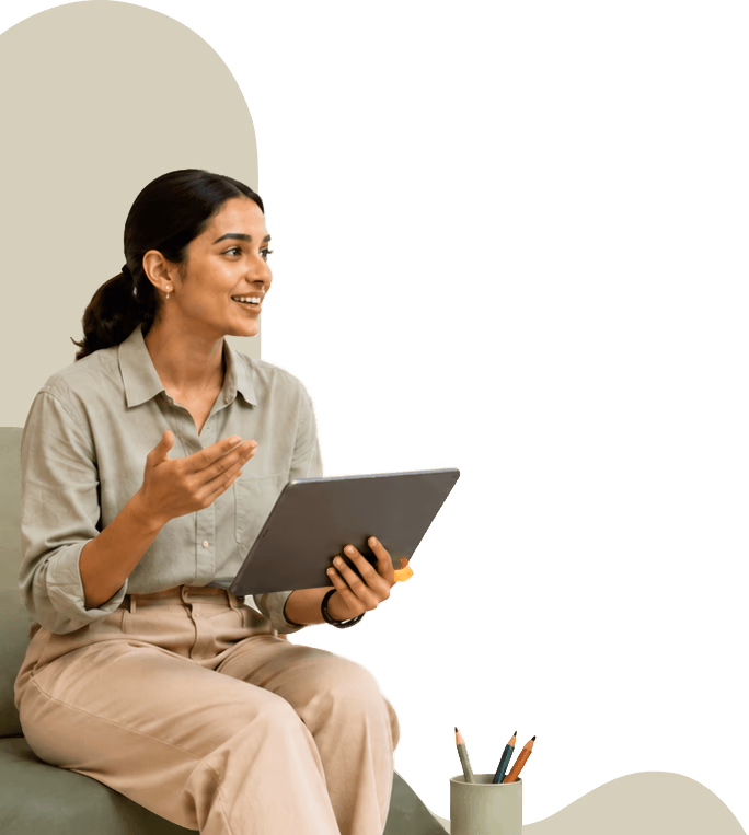 Student sitting on a stack of books reading
